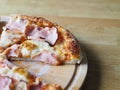 baked and sliced Ã¢â¬â¹Ã¢â¬â¹pizza with cheese, ham and sauce